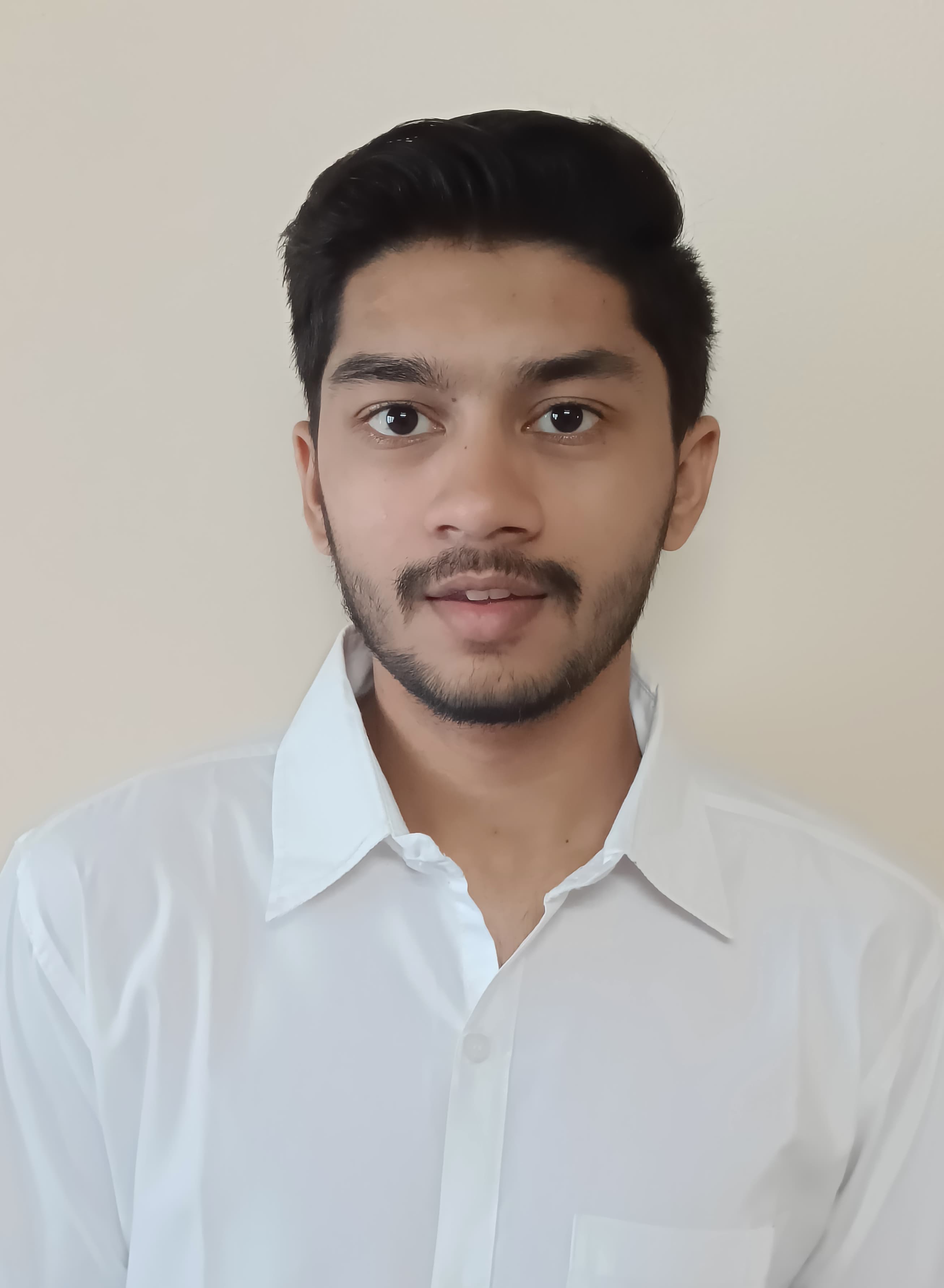 Profile picture of Susim Mukul Roy standing in a field with trees in the background